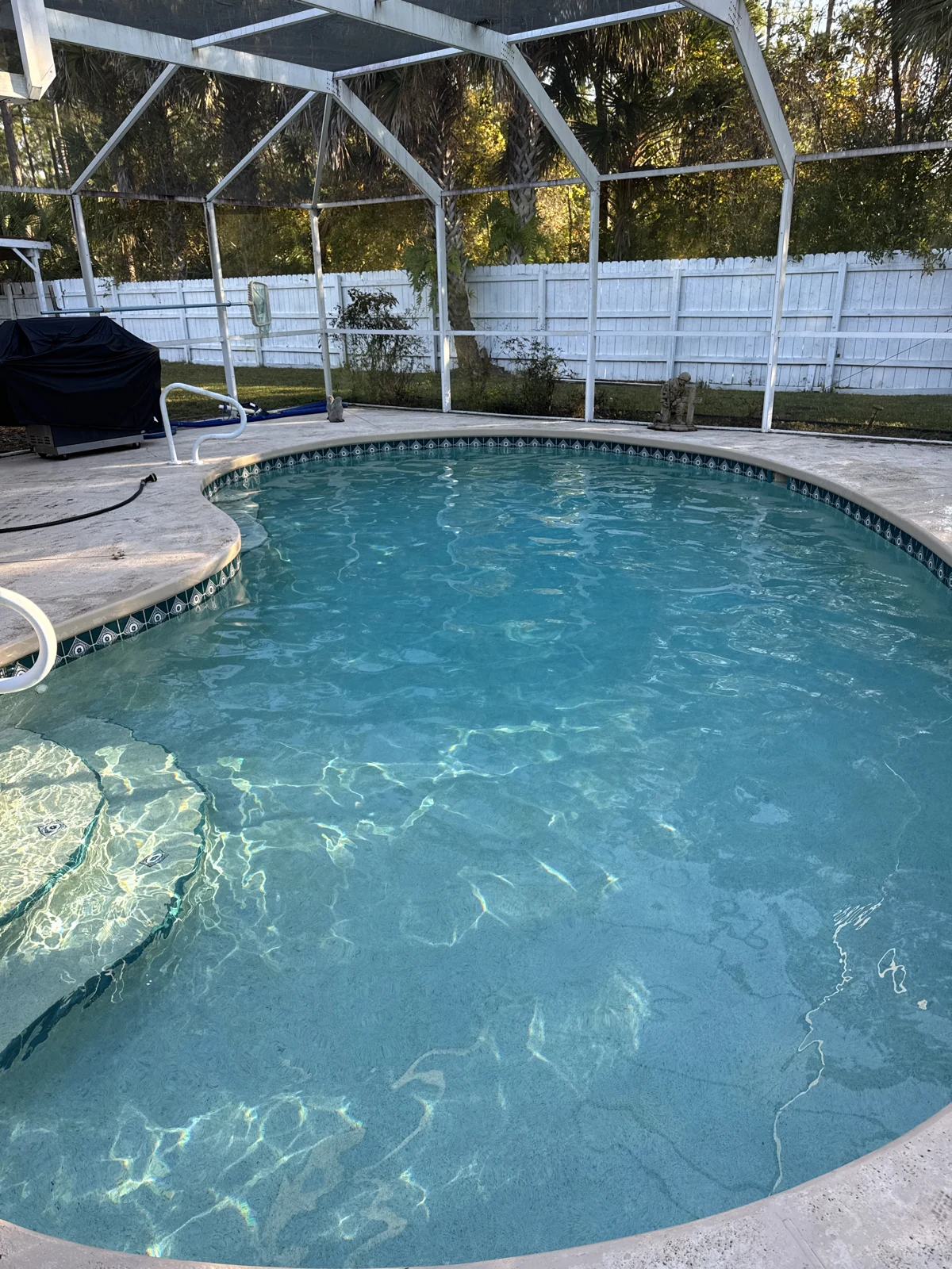 Sunlit water in a screened residential pool
