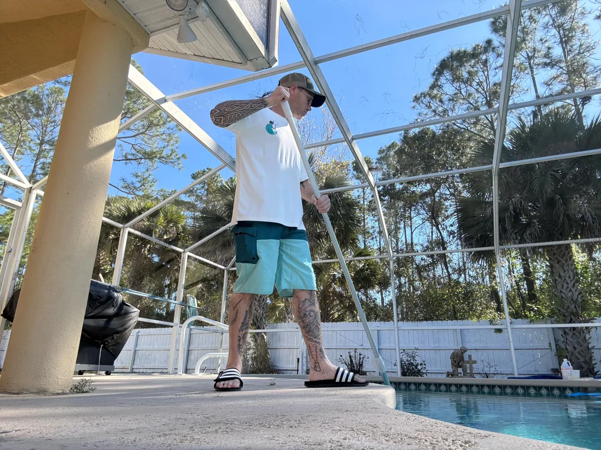 Edward McLaughlin working beside a pool